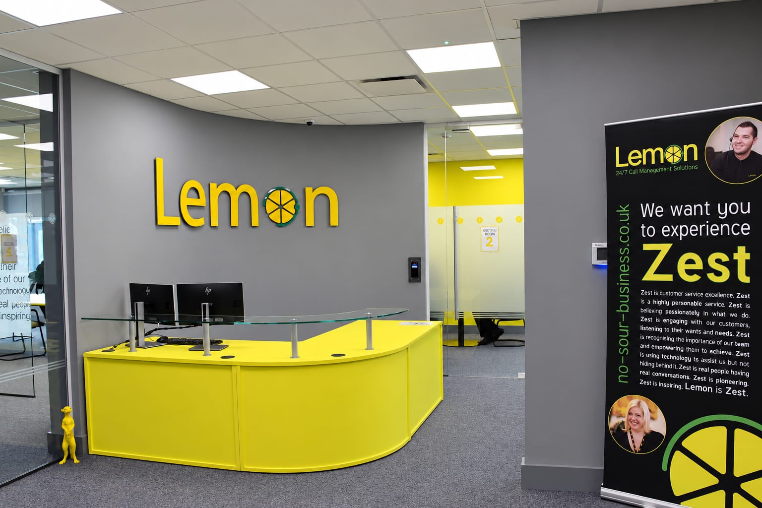 Lemon Business Solutions: reception with the yellow front desk and Lemon wall sign